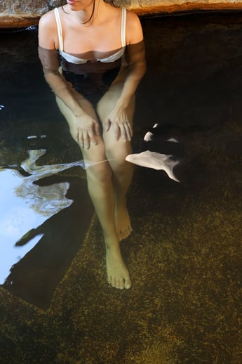 Woman bathing in hot springs water