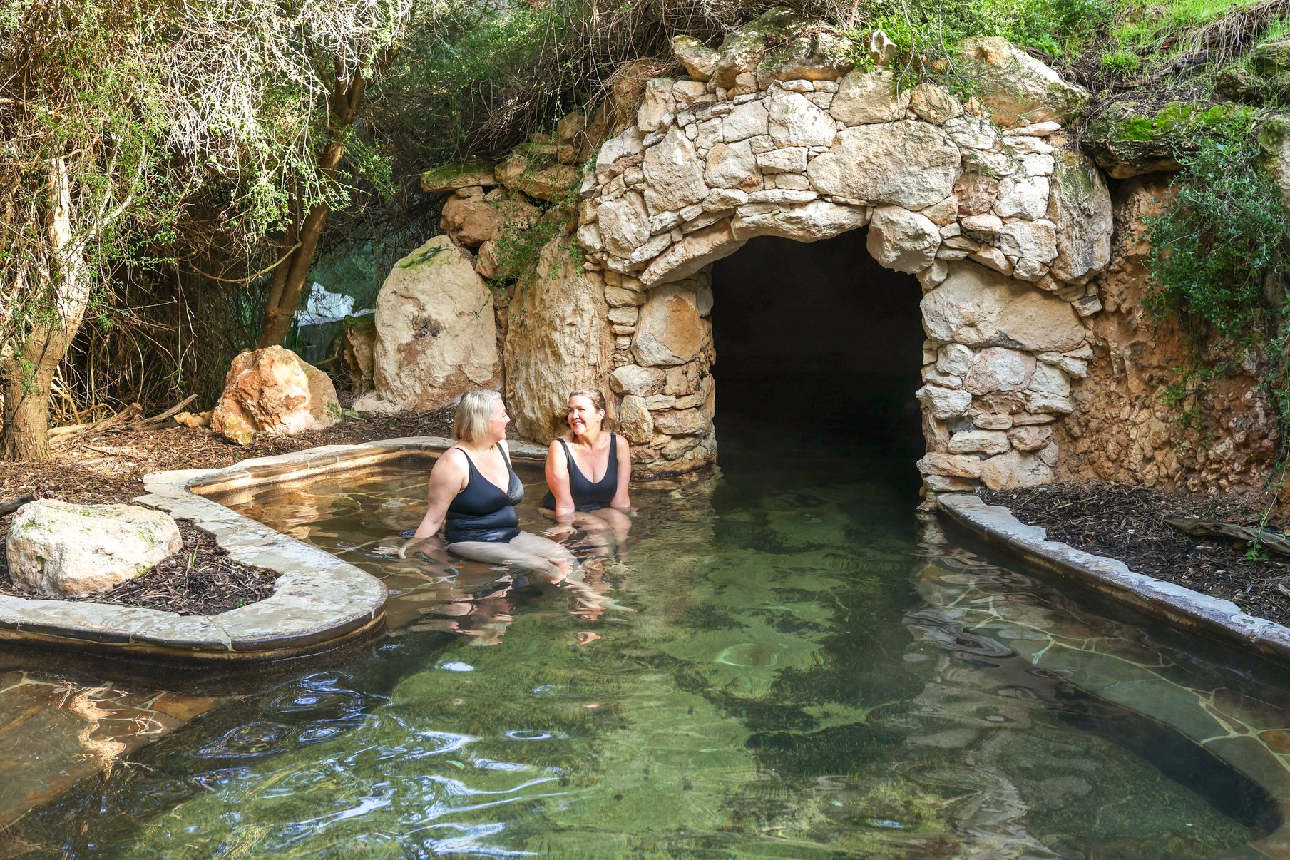 Two people bathing in the Cave Pool
