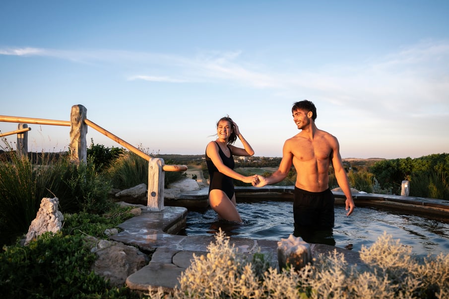 A couple walking through the Hilltop pool