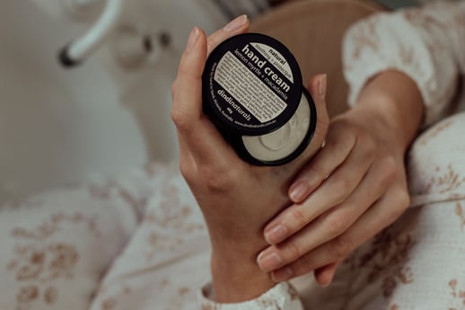 A woman holding Dindi Naturals handcream