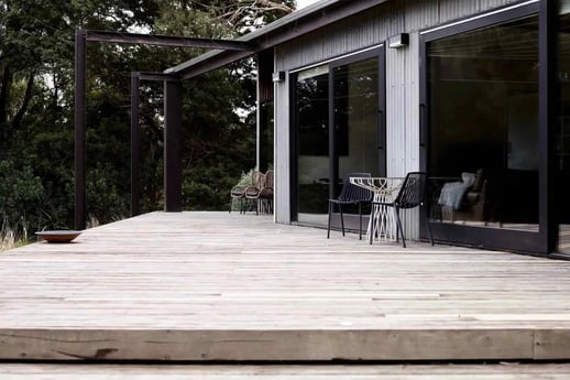 A wooden deck leading to a house