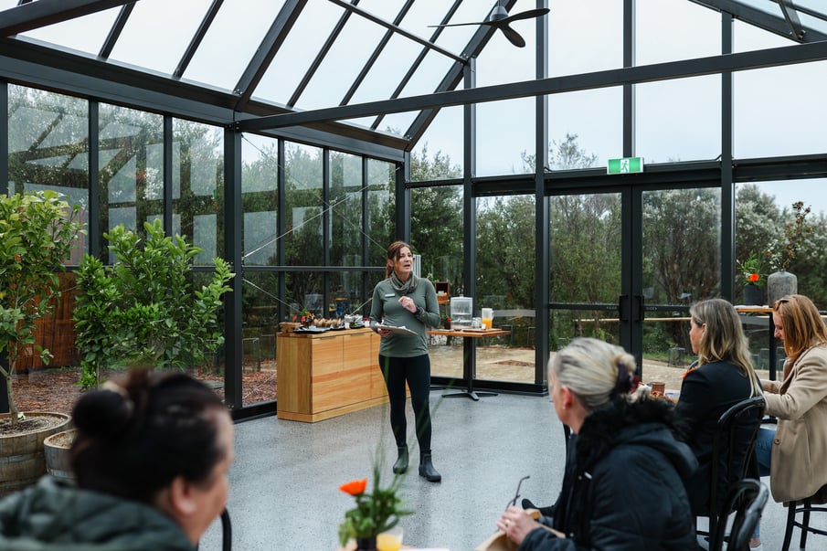 A wellness host talking to a group of people during the Nourish Workshop