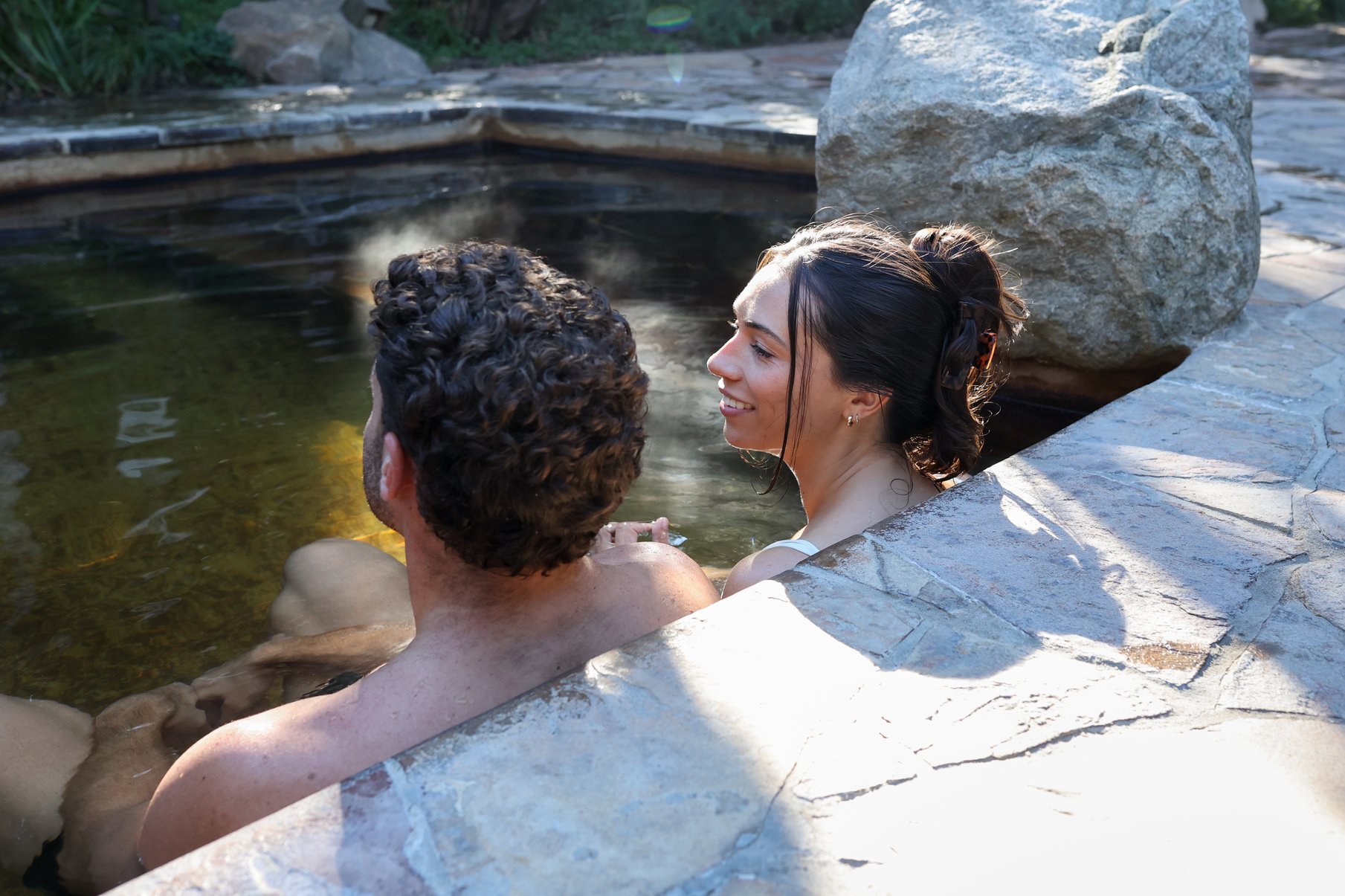 A couple bathing in the hot springs of the Spa Dreaming Centre