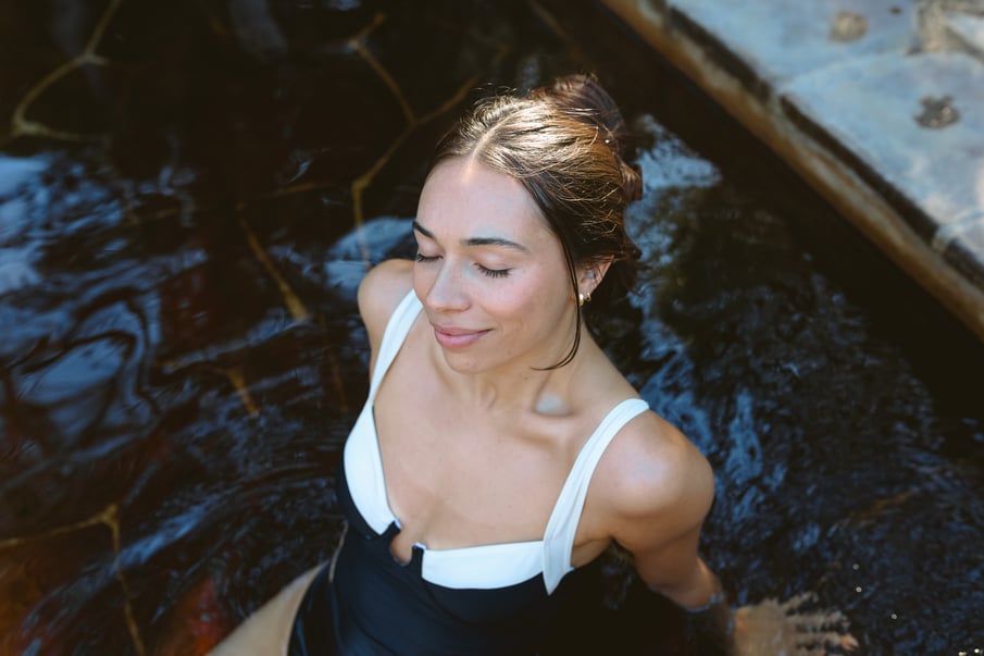 A woman bathing in geothermal springs