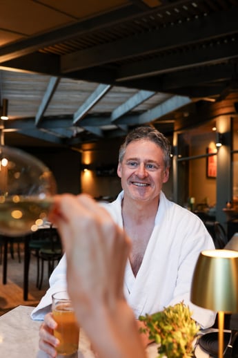A man in a white robe dining in the Spa Dreaming Centre