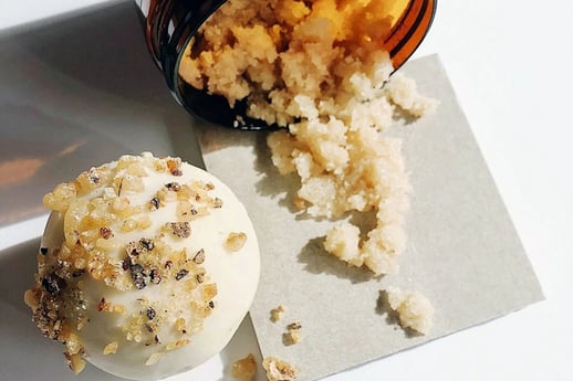 Bath salts laid on a table from a jar