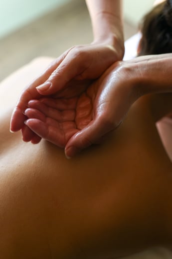 A person receiving a back massage