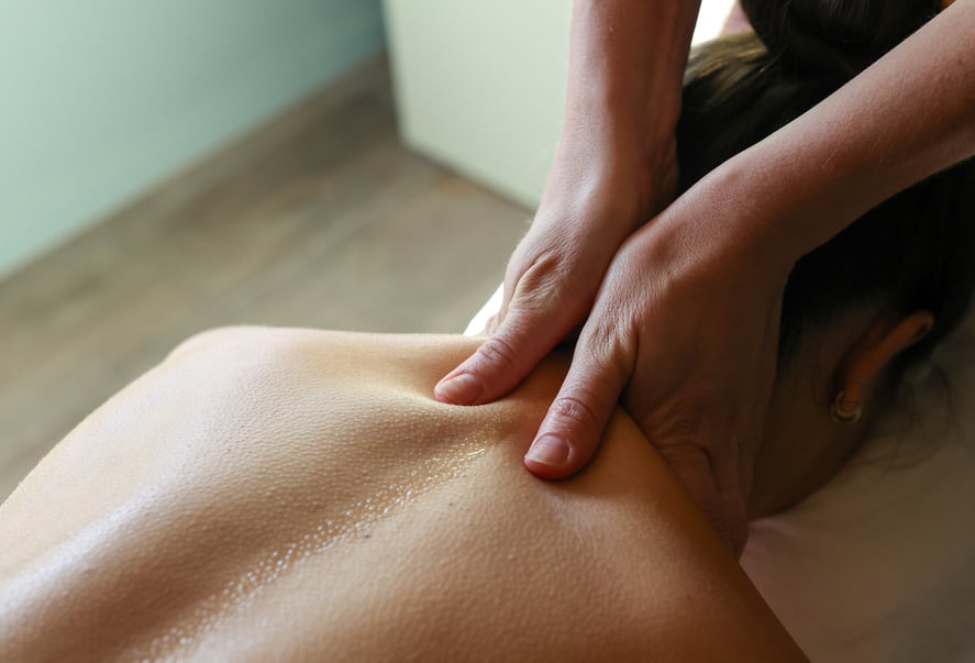 A woman receiving a back massage