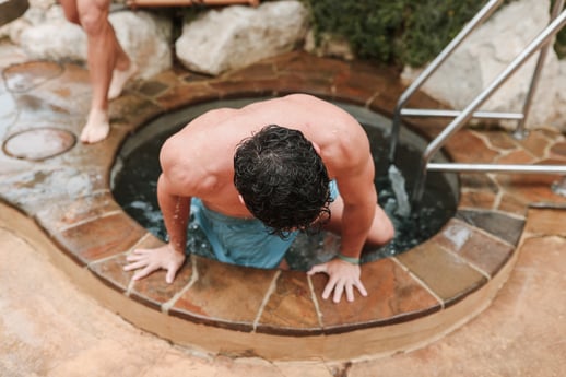 A man getting into the cold plunge pool